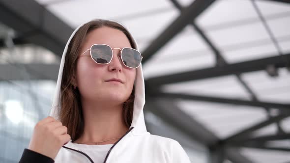 Girl in Sunglasses and a Hood on Her Head