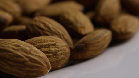 Cinematic, rotating shot of almonds on a white surface - ALMONDS 038