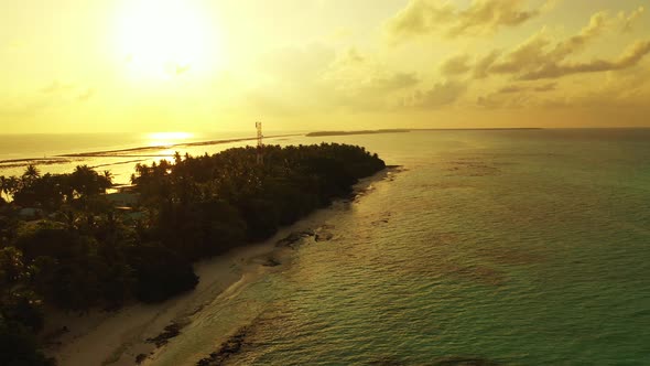 Wide angle above clean view of a white sandy paradise beach and blue water background in colourful 4