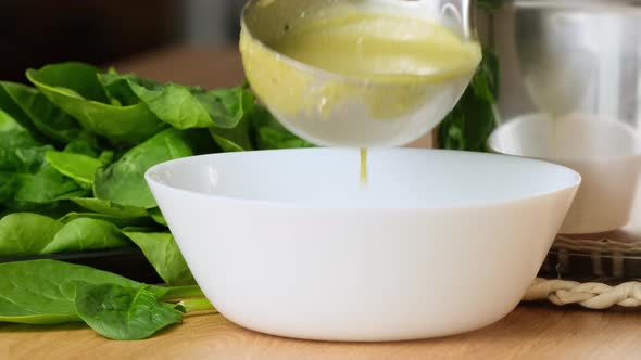 Spinach creamy soup, vegetarian food closeup. Serving a tasty creamy spinach soup