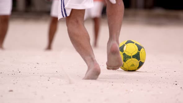 Slow motion pan of soccer game at Tavares Bastos Favela in Rio de Janeiro, Brazil