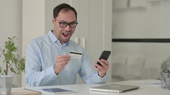 Middle Aged Man Having Online Payment Success on Smartphone