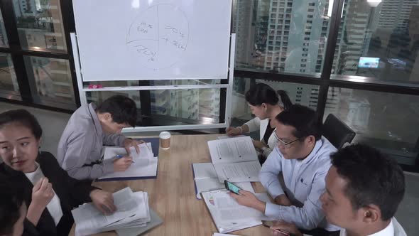 Asian Business People Discuss Marketing Strategy