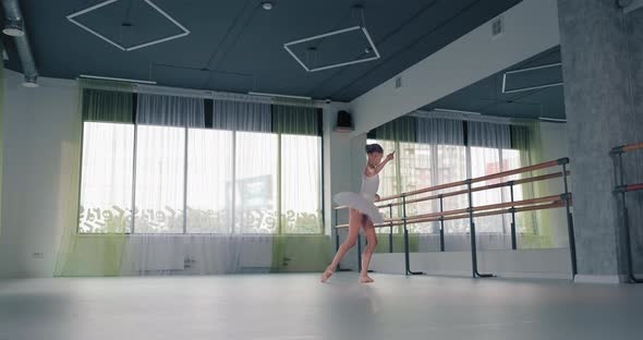 Girl in Tutu Dances Ballet in Studio