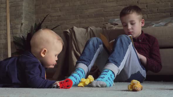  - Older Brother Playing with Younger Baby Girl