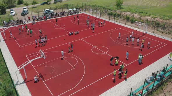 Aerial View of Young Athletes Playing Basketball on an Open Public Basketball Court
