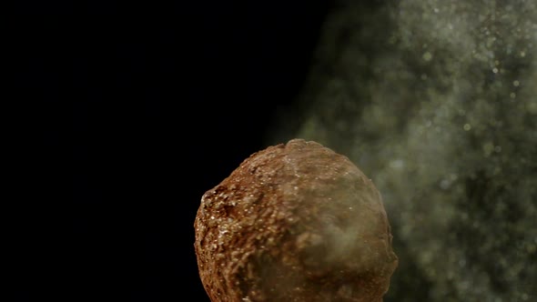 Chef Blows Golden Dust on Rotating Handmade Luxury Truffle Ball Close Up Slow Mo