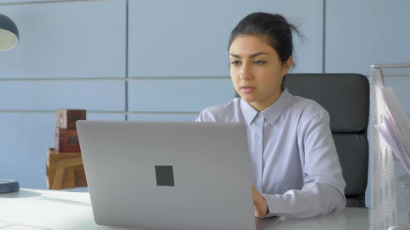 A Young Indian Woman Freelancer Works On An Online Project At A Computer Laptop