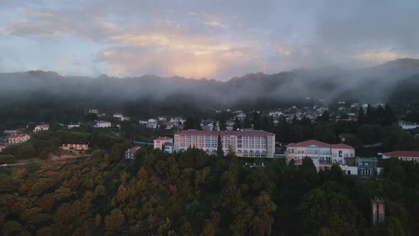 Low clouds over Golden Tulip Caramulo Hotel and SPA at sunrise, Portugal. Aerial panoramic view