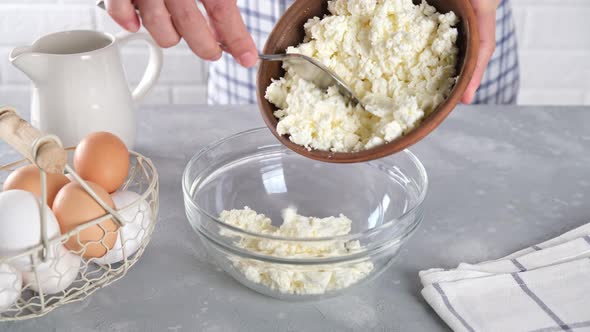 Cottage cheese, farmer's cheese in a glass bowl on the table