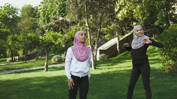 Two Darkskinned Muslim Women in Sportswear and Colorful Hijabs