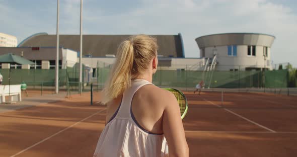 Back View of Sexy Tennis Player Hitting the Ball on Clay Court Slow Motion