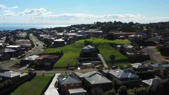 AERIAL Coastal Township With Housing Community And Vacant Land