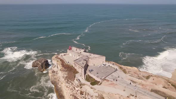 People on belvedere of Nazare lighthouse. Aerial panoramic view