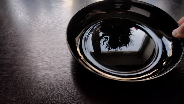 cutlery is placed on a wooden kitchen table to a plate