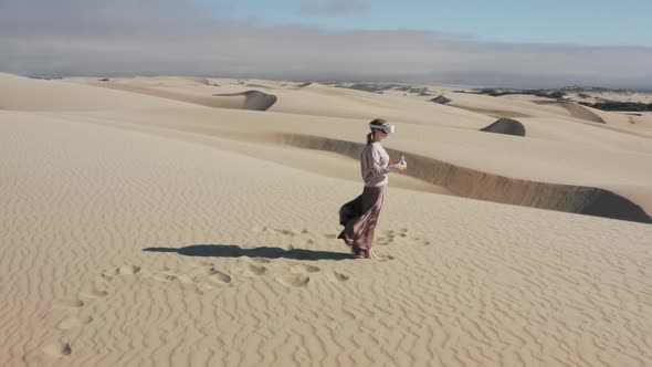 Aerial  Shot Female in AR Outdoors Cinematic Desert Sand Dunes on Sunny Summer