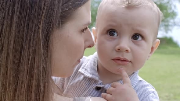 Mother Holding Curious Little Boy alt