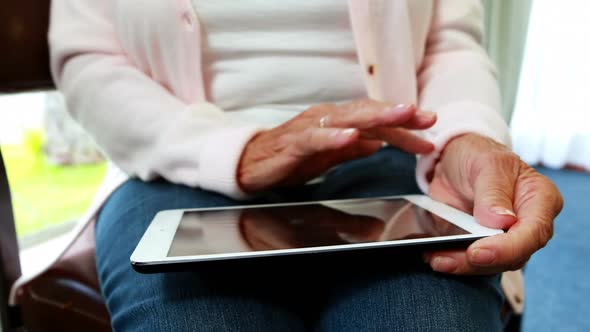 close up view of retired woman using a tablet pc