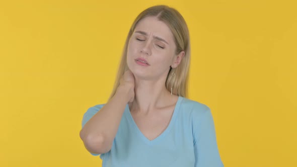 Young Woman with Neck Pain on Yellow Background