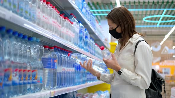 Customer in the Supermarket Buying Mineral Water