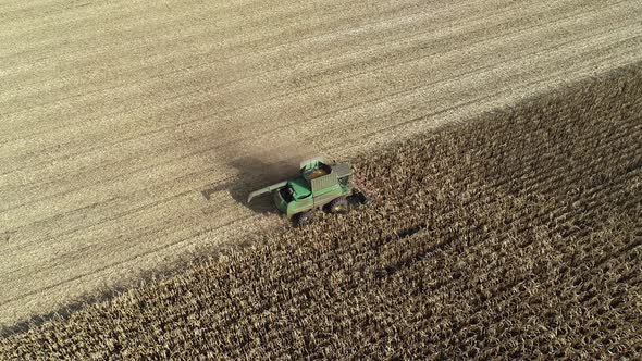 Aerial View of a Harvester Harvesting Corn in the Field