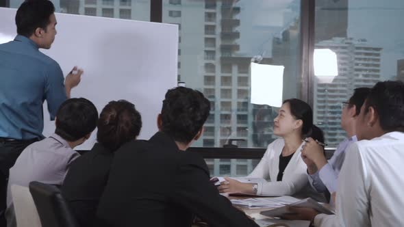 Asian Business People Discuss Marketing Strategy