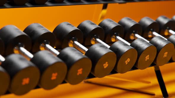 Dumbbells row on a special rack in a gym or fitness club. Sport, bodybuilding.