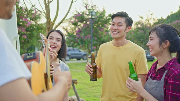 Group of Asian man and woman friends traveler have holiday trip picnic party together on camping van