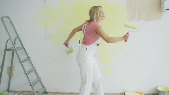 Relaxed Woman Dancing with Paint Roller