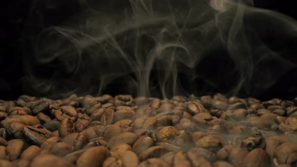 Close-up of seeds of coffee. Fragrant coffee beans are roasted smoke that comes from coffee beans. 