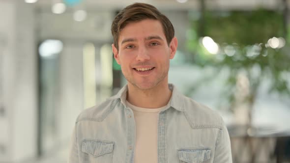 Portrait of Creative Young Man Talking on Online Video Call