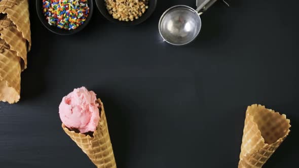 Waffle ice cream cones with scoops of ice cream.