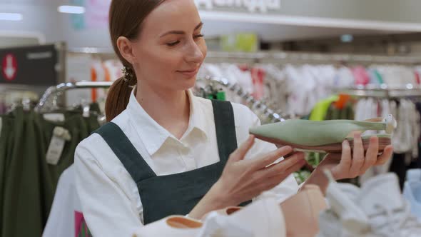 Young Customer Chooses Shoes in Market for Walking Closeup