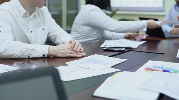 Colleagues Passing Document to Boss, Employee Looking at Fluctuation Graph