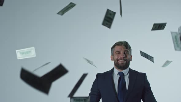 Happy Businessman Throwing Money in Air