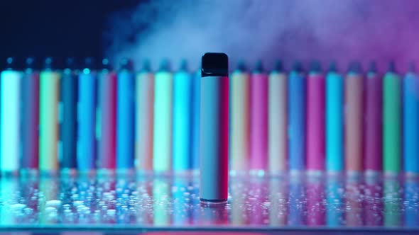 ECigarettes and Vapes with Smoke in Neon Lighting