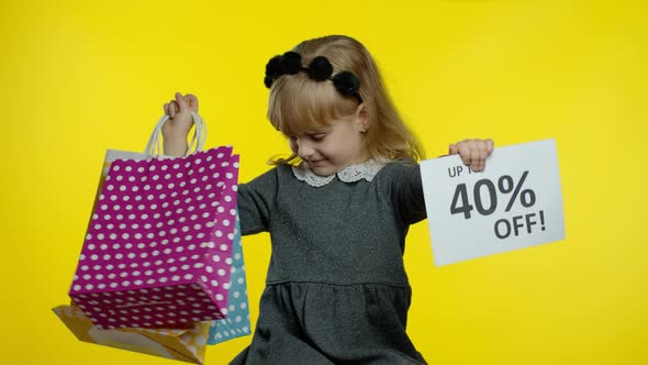 Child Girl Showing Up To 40 Percent Off Inscription Sign and Shopping Bags. Teen Pupil Smiling