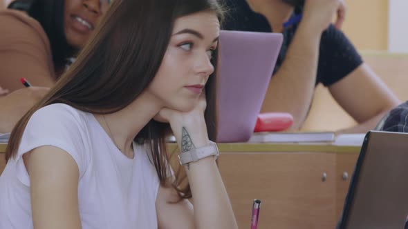 Group of Racially Mixed Young Students Listening To Lecture