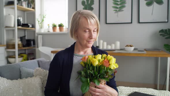 Video portrait of senior woman with bouquet of flowers. Shot with RED helium camera in 8K.