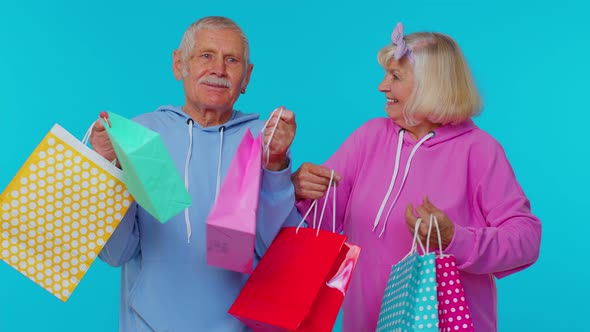 Senior Grandmother Grandfather Showing Shopping Bags Advertising Price Discounts Black Friday Sale