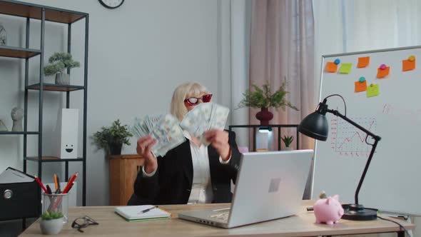 Business Woman Accountant Celebrating Business Success Dancing with Stack of Money Dollar Cash