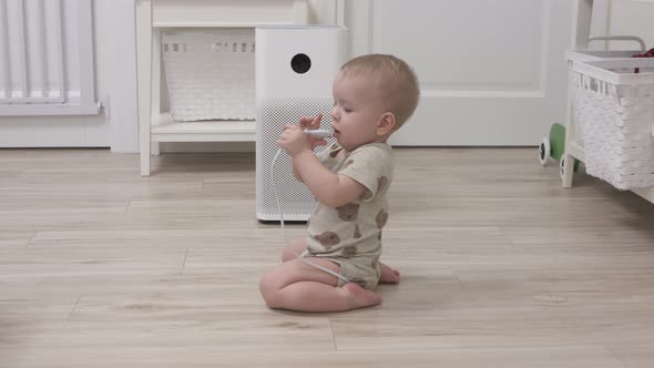 Toddler Playing with Electric Wire on Floor at Living Room 1 Year Old Infant Holding the Electric