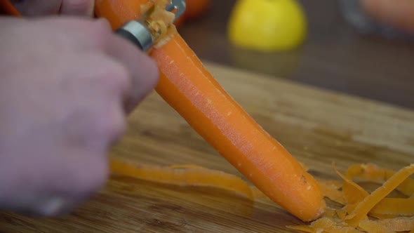 Peeling fresh, ripe, whole carrot - Slow motion