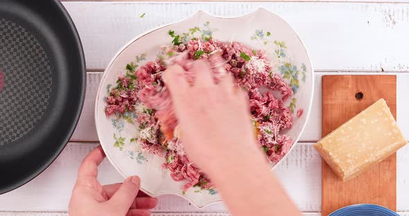 Hand mixing meatballs ingredients
