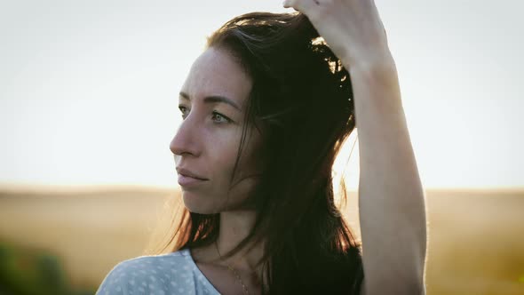 Portrait of Young Woman Looking Up at Sunset Sky