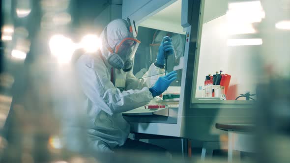 Professional Virologist Works with Antibodies in Laboratory. alt