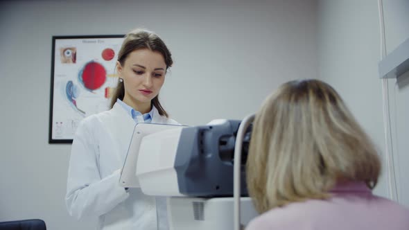 The Ophthalmologist Examines the Patient's Eye and Then Looks Into the Camera