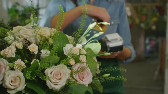 Female Cashier Selling Flower Bouquet