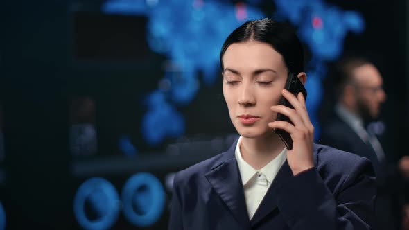 Professional Asian Female Finance Trader Talking Smartphone at Stock Exchange