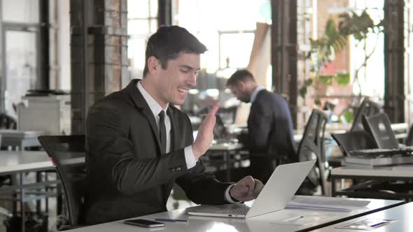 Online Video Chat on Laptop at Work By AfroAmerican Man